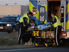 Essex-Windsor EMS paramedics treat a woman who was involved in a single vehicle accident on west-bound E.C. Row Thursday, November 14, 2013. (NICK BRANCACCIO/The Windsor Star)