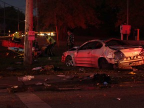 Emergency personnel work at the scene of a single-vehicle accident at the intersection of Front Road and Middle Side Road in Amherstburg, Ont., Sunday, Nov. 3, 2013.  Two males were sent to hospital with unknown injuries.  (DAX MELMER/ The Windsor Star)