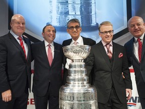 Scott Moore, left, president of broadcast, Rogers Media, NHL Commissioner Gary Bettman, Nadir Mohamed, president and CEO, Rogers Communications, Keith Pelley, president, Rogers Media,and NHL Deputy Commissioner Bill Daly pose for a photo after announcing a 12-year national broadcast and multimedia agreement on November 26, 2013 in Toronto.  (Aaron Vincent Elkaim/Getty Images)