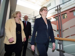 In this file photo, Ontario Premier Kathleen Wynne, right, and Health Minister Deb Matthews, left, and Research and Innovation Minister Reza Moridi tour the Louise Temerty Breast Cancer Centre at Sunnybrook Health Sciences Centrel in Toronto on Thursday April 4, 2013. (THE CANADIAN PRESS/Frank Gunn)