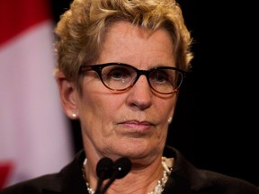 Ontario Premier Kathleen Wynne speaks to the media at Queen's Park in Toronto on Tuesday, Oct. 8, 2013. Canada is headed for a "huge economic crisis" if the provinces and federal government don't take action now to improve retirement incomes, Wynne warned. (THE CANADIAN PRESS/Nathan Denette)