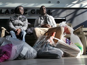 Kuuku Quagraine (L) and Opeyemi Nathan Sanni take a break from shopping at the Devonshire Mall on Black Friday, Nov. 29, 2013, in Windsor, Ont. (DAN JANISSE/The Windsor Star)