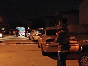 An unidentified parent waits on a child at the scene of a suburban Houston shooting early Sunday Nov. 10, 2013. Two people have been killed and at least 22 others hurt when gunfire rang out at the large house party in the Cypress-area of Houston, sending partygoers fleeing in panic, according to authorities. (AP Photo/Houston Chronicle, Anita Hassan)