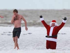 People take part in the fifth annual Polar Splash at Belle River Beach, Sunday, Nov. 24, 2013.  The event was raising funds for the Lakeshore Community Food Bank and the Community Support Centre of Essex County.  (DAX MELMER/The Windsor Star)