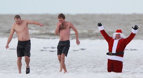 People take part in the fifth annual Polar Splash at Belle River Beach, Sunday, Nov. 24, 2013.  The event was raising funds for the Lakeshore Community Food Bank and the Community Support Centre of Essex County.  (DAX MELMER/The Windsor Star)