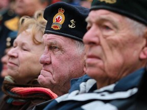 Martin Vermeer, 80, right, and Bill Major, 81, centre, both Korean War veterans, attend the Remembrance Day ceremony at the cenotaph in downtown Windsor, Monday, Nov. 11, 2013.  (DAX MELMER/The Windsor Star)