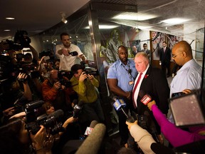 Toronto Mayor Rob Ford addresses media outside his office in Toronto on Thursday, Oct. 31, 2013. Ford says he has no reason to step down despite police confirmation that they have seized a video media have alleged appears to show him smoking crack cocaine.THE CANADIAN PRESS/Nathan Denette