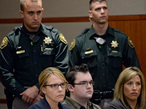 Sheriff's deputies stand behind Austin Sigg, front centre, as he sits in district court in Golden, Colo., on Tuesday, Nov. 19, 2013, during his sentencing hearing. Sigg, 18, who killed and dismembered 10-year-old Jessica Ridgeway in October 2012 was ordered Tuesday to spend the rest of his life in prison. He would have been eligible for parole on the murder charge in 40 years because he was a juvenile at the time, but the judge added on sentences for other crimes that Sigg pleaded guilty to, eliminating that possibility. (AP Photo/Denver Post, RJ Sangosti, Pool)