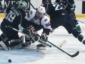 Windsor's Cristiano DiGiacinto, centre, fails to put the puck past Plymouth goalie, Alex Nedejkovic, left, as the Windsor Spitfires host the Plymouth Whalers at the WFCU Centre, Sunday, Nov. 24, 2013.  Windsor lost 2-1.  (DAX MELMER/The Windsor Star)