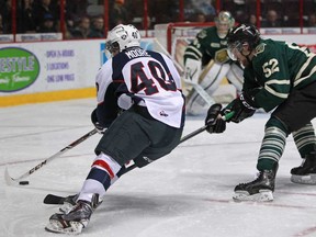 Windsor's Ryan Moore, left, tries to get past London's Alex Basso for a scoring opportunity, as the Windsor Spitfires host the London Knights in OHL action at the WFCU Centre, Sunday, Nov. 10, 2013.  (DAX MELMER/The Windsor Star)
