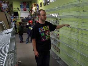 Francis Roy McLean, owner of The Game MD in Windsor, Ont., lost $70,000 in merchandise to thieves last weekend.  In photo, McLean, shown Wednesday, Nov. 6, 2013, will be re-stocking his empty inventory racks.  (NICK BRANCACCIO/The Windsor Star)