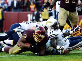 Darrel Young #36 of the Washington Redskins scores the game-winning touchdown in overtime against the San Diego Chargers during an NFL game at FedExField on November 3, 2013 in Landover, Maryland. The Redskins defeated the Chargers 30-24. (Patrick McDermott/Getty Images)