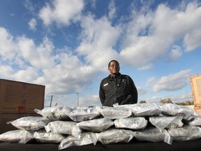 The United States Customs and Border Protection service recently seized 156 pounds of marijuana valued at $626,000 US in a shipment of frozen vegetables. CBP Office of Field Operations Chief Ken Hammond poses Thursday, Nov. 7, 2013, with the marijuana during a press event at the Fort Street cargo facility in Detroit. (DAN JANISSE/The Windsor Star)