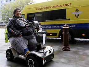 Kevin Chenais sits in his mobility scooter in front of an ambulance at St. Pancras in London, Wednesday, Nov. 20, 2013. Kevin, who suffers from a medical condition will travel by ambulance and ferry back to France. (AP Photo/Kirsty Wigglesworth)