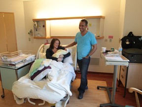 Newborn baby Adonis Arrieta is held by his mother Larissa Horbatiuk,along with his father Fernando, at Windsor Regional Hospital, Met Campus, on Nov. 26, 2013, in Windsor, Ontario.  (JASON KRYK/The Windsor Star)