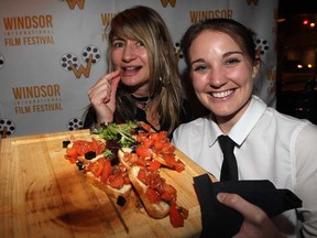 Mary Hrovat, left, samples tasty bruschetta served by Holly Smith during WIFF Opening Night Gala at The City Grill in Windsor, Ont., following the showing of film Gabrielle, Tuesday November 5 , 2013. (NICK BRANCACCIO/The Windsor Star)