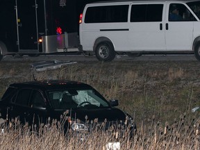 A black SUV sits in the south ditch of Hwy. 401 with airbags deployed following an incident possibly involving a transport truck Wednesday November 20, 2013.  Hwy. 401 east bound has been shut down for at least two hours while Essex OPP investigate and two Chatham-Kent police cruisers were on the scene.  Also, an ambulance was seen leaving the area under police escort. (NICK BRANCACCIO/The Windsor Star)