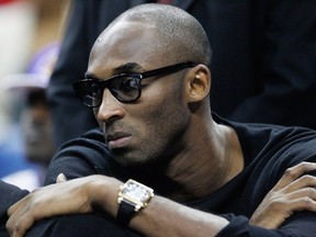 Los Angeles guard Kobe Bryant watches the Lakers against the New Orleans Pelicans in New Orleans. (AP Photo/Bill Haber)