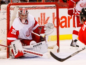 Ottawa's Chris Campoli, right scores a goal on Detroit's Jimmy Howard. (Photo by Jean Levac, Ottawa Citizen)