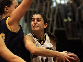 Amherst's Robin Kellam, right, drives on Bridget O'Reilly of St. Michael in OFSSA girls basketball held at Catholic Central Friday. (NICK BRANCACCIO/The Windsor Star)