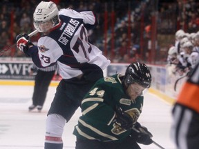 Windsor's Remy Giftopoulos, left, avoids a collision with London's Dakota Mermis at the WFCU Centre earlier this month. (DAX MELMER/The Windsor Star)