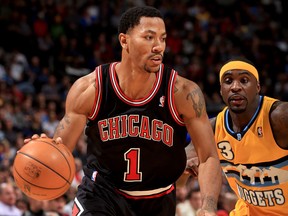 Chicago's Derrick Rose, left, is guarded by Denver's Ty Lawson. (Photo by Doug Pensinger/Getty Images)