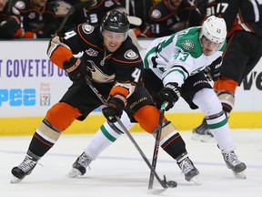 Former Spitfire Cam Fowler, left, is checked by Valeri Nichushkin of the Stars at American Airlines Center. (Photo by Ronald Martinez/Getty Images)