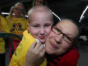 Aubri Andre, 7, gives her mother Lisa Andre an enormous hug during a well-attended fundraiser at Colasanti's Tropical Gardens Friday November 29, 2013. Aubri and her family will be travelling to Calgary for special medical treatment.  About 1,000 brought their best wishes to Friday's event. (NICK BRANCACCIO/The Windsor Star)