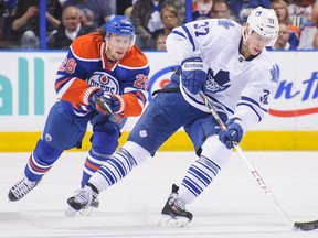 Toronto's Carter Ashton, right, is checked by Edmonton's Ryan Jones at Rexall Place. (Photo by Derek Leung/Getty Images)
