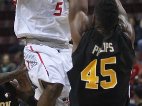 Windsor's Stefan Bonneau, left, goes up for a shot against London's Marvin Phillips during the team's home opener at the WFCU Centre. (DAN JANISSE/The Windsor Star)