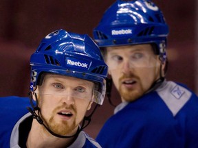 Daniel, left, and Henrik Sedin signed four-year contract extensions with the Vancouver Canucks. (THE CANADIAN PRESS/Darryl Dyck)