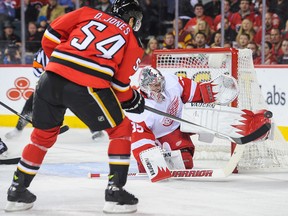 Detroit goalie Jimmy Howard, right, makes a save on Calgary's David Jones at Scotiabank Saddledome. (Photo by Derek Leung/Getty Images)