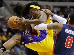 Detroit's Andre Drummond, right, fouls Jordan Hill of the Lakers at the Palace of Auburn Hills. (AP Photo/Carlos Osorio)