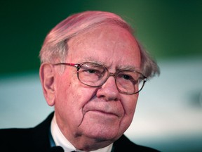 In this file photo, Warren Buffett, Chairman and CEO of Berkshire Hathaway and Co-Chairman of Goldman Sachs 10,000 Small Businesses Program, attends a press conference November 26, 2013 at Ford Field in Detroit. (Bill Pugliano/Getty Images)