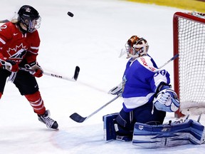 Finland goalie Noora Raty, right, makes a save on Ruthven's Meghan Agosta-Marciano during the third period of a Four Nations Cup women's hockey game Tuesday in Lake Placid, N.Y. (AP Photo/Mike Groll)