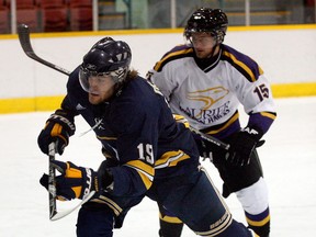 University of Windsor forward Josh Graves, left, skates through the crease in front of Laurier's Adam Hughes at Windsor Arena last year. (NICK BRANCACCIO/The Windsor Star)