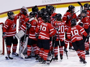 Team Canada players celebrate a 4-2 win over the United States in a Four Nations Cup game in Lake Placid, N.Y. (AP Photo/Mike Groll)