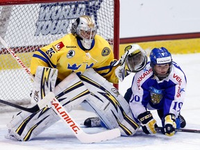 Sweden goalie Valentina Wallner, left, looks to make a save in front of Finland's Linda Valimaki during the Four Nations Cup in Lake Placid, N.Y. (AP Photo/Mike Groll)