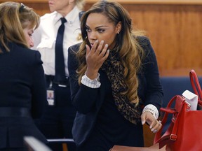 Shayanna Jenkins, the girlfriend of former New England Patriots football player Aaron Hernandez, talks with her defense attorney, Janice Bassil, left, at the conclusion of a pre-trial conference at Fall River Superior Court in Fall River, Mass. (AP Photo/The Boston Globe, Jonathan Wiggs, Pool)