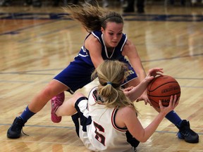 St. Anne's Brielle Loebach, left, battles Maddie Bevacqua of Holy Names during the high school girls basketball final. (NICK BRANCACCIO/The Windsor Star)