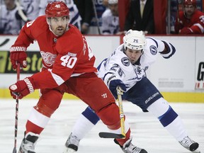 Detroit's Henrik Zetterberg, left, is checked by Tampa Bay's Martin St. Louis at Joe Louis Arena. (DAX MELMER/The Windsor Star)