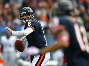 Chicago's Jay Cutler, left, prepares to throw the ball against the Detroit Lions at Soldier Field. (Photo by Jonathan Daniel/Getty Images)