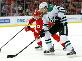 Dallas forward Tyler Seguin, right, is checked by Detroit' Pavel Datsyuk. (AP Photo/Paul Sancya)