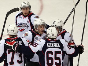 Spitfires goalscorer Remy Giftopoulos, left, is congratulated by teammates Kerby Rychel, top, Nick Ebert, Slater Koekkoek and Brady Vail against the Plymouth Whalers at the WFCU Centre. (NICK BRANCACCIO/The Windsor Star)