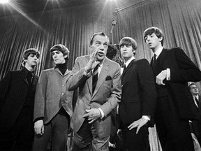 In this Feb. 9, 1964 photo, Ed Sullivan, center, stands with The Beatles, from left, Ringo Starr, George Harrison, John Lennon, and Paul McCartney, during a rehearsal for the British group's first American appearance, on the Ed Sullivan Show, in New York. CBS is planning a two-hour special on Feb. 9, 2014, to mark the 50th anniversary of the Beatles’ groundbreaking first appearance on “The Ed Sullivan Show.” (AP Photo, File)