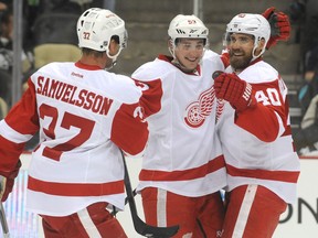 Detroit's Adam Almquist, centre,  is congratulated by teammates Mikael Samuelsson, left, and Henrik Zetterberg in Pittsburgh. (Photo by Vincent Pugliese/ Getty Images)