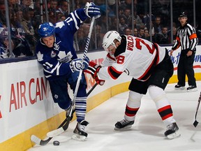 New Jersey's Anton Volchenkov, right, checks David Clarkson of the Maple Leafs Friday at the Air Canada Centre. (Photo by Bruce Bennett/Getty Images)