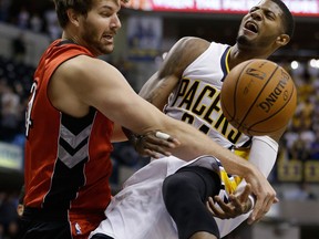Indiana's Paul George, right, is fouled by Toronto's Aaron Gray Friday in Indianapolis. (AP Photo/Darron Cummings)