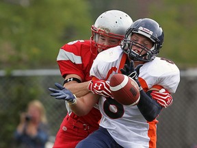 Sandwich's Rik Van Espen, right, is tackled by Brennan's Jackson Atkin  in Windsor. (TYLER BROWNBRIDGE/The Windsor Star)