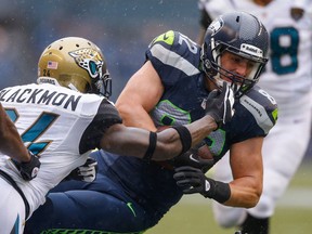 LaSalle's Luke Willson, right, is tackled by Jacksonville's Will Blackmon at CenturyLink Field. (Photo by Otto Greule Jr/Getty Images)